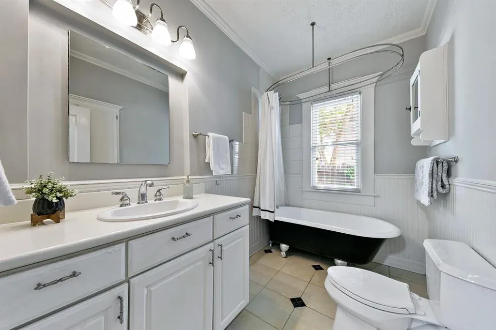 Before: Bathroom remodel in Travis Heights, Austin, TX with a clawfoot tub and a white vanity