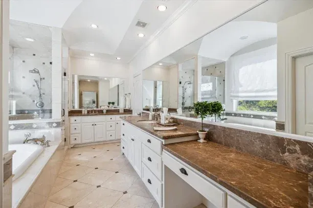 Before: Bathroom remodel in Westlake Hills, Austin, TX with brown granite counters and a garden tub